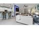 Open-concept living room featuring a fireplace, television, and a breakfast bar at 12272 Stuart Dr, Venice, FL 34293