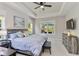 Spacious main bedroom with modern decor, tray ceiling, and views of the private backyard at 12272 Stuart Dr, Venice, FL 34293