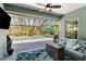 Inviting screened lanai with a cozy seating area, fire pit, and views of the pool and lush backyard at 12272 Stuart Dr, Venice, FL 34293