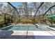 Beautiful pool area with lush landscaping and a spa, enclosed within a screened lanai for year-round enjoyment at 12272 Stuart Dr, Venice, FL 34293
