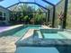 Beautiful screened-in pool and spa with lush landscaping provides the ultimate in outdoor enjoyment at 12272 Stuart Dr, Venice, FL 34293