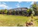View of the screened patio with lovely garden in this beautiful backyard, ideal for outdoor enjoyment at 12272 Stuart Dr, Venice, FL 34293
