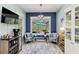 Cozy sitting area featuring large windows overlooking the pool, comfortable seating, and stylish decor at 12272 Stuart Dr, Venice, FL 34293