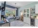This bonus sitting area in the kitchen includes a beverage fridge and access to the pool at 12272 Stuart Dr, Venice, FL 34293