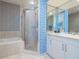 Stylish bathroom with a walk-in shower, soaking tub, double vanity, and modern finishes, creating a luxurious space at 1281 Gulf Of Mexico Dr # 704, Longboat Key, FL 34228