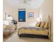 Cozy bedroom featuring a wicker chair, dresser, and serene decor with an ocean view seen through the window at 1281 Gulf Of Mexico Dr # 704, Longboat Key, FL 34228