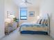Inviting bedroom with a calming color scheme, complemented by a beautiful beachfront view and wicker furniture at 1281 Gulf Of Mexico Dr # 704, Longboat Key, FL 34228