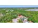Expansive aerial view of a private home nestled in a lush, green landscape and a screened-in pool at 15107 3Rd E Dr, Bradenton, FL 34212