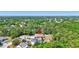 Aerial view of a single-story home nestled among green trees and other homes in a lush community at 15107 3Rd E Dr, Bradenton, FL 34212
