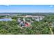 Stunning aerial view of a beautiful home nestled among trees, complete with a nearby lake and surrounding community at 15107 3Rd E Dr, Bradenton, FL 34212