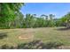 Expansive backyard with a fire pit and lush greenery, offering endless possibilities at 15107 3Rd E Dr, Bradenton, FL 34212