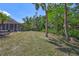 Lush backyard featuring green lawn, mature trees and manicured landscape beds with brick borders at 15107 3Rd E Dr, Bradenton, FL 34212