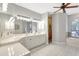 Bright bathroom with double sinks, quartz countertops, a soaking tub, and a separate shower stall at 15107 3Rd E Dr, Bradenton, FL 34212