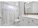 Bright bathroom features a shower with a decorative curtain, plus a vanity with storage at 15107 3Rd E Dr, Bradenton, FL 34212