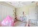Adorable bedroom featuring white trim, a playful pink tent, and stylish decor at 15107 3Rd E Dr, Bradenton, FL 34212