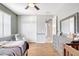 Cozy bedroom with wood floors, gray walls, a ceiling fan, and ample storage with a large dresser at 15107 3Rd E Dr, Bradenton, FL 34212