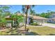 Charming exterior with manicured landscaping, a three-car garage, and a welcoming front yard at 15107 3Rd E Dr, Bradenton, FL 34212
