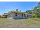Exterior of a home with a backyard, screened-in porch, and ample lawn space at 15107 3Rd E Dr, Bradenton, FL 34212
