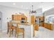 Spacious kitchen with stainless steel appliances, granite countertops, and a cozy breakfast bar at 15107 3Rd E Dr, Bradenton, FL 34212