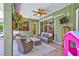 Relaxing lanai offers outdoor seating, a ceiling fan, and a mounted TV for entertainment at 15107 3Rd E Dr, Bradenton, FL 34212