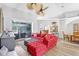 Bright open-concept living area with wood floors, plush sofa, and seamless flow to the dining area at 15107 3Rd E Dr, Bradenton, FL 34212