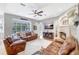 Cozy living room with brick fireplace and bright windows looking out at the pool at 15107 3Rd E Dr, Bradenton, FL 34212