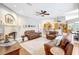 Large living room with brick fireplace and view of the kitchen area at 15107 3Rd E Dr, Bradenton, FL 34212