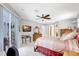 Bright main bedroom features a ceiling fan, neutral walls, and an adjoining bathroom and walk-in closet at 15107 3Rd E Dr, Bradenton, FL 34212