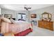 Tranquil main bedroom features a sliding glass door, ceiling fan, and comfortable furnishings at 15107 3Rd E Dr, Bradenton, FL 34212