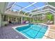 Beautiful pool area featuring a screened enclosure, lounge chairs, and outdoor kitchen at 15107 3Rd E Dr, Bradenton, FL 34212
