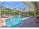Inviting screened pool area with comfortable lounge chairs, perfect for relaxation and leisure at 15107 3Rd E Dr, Bradenton, FL 34212
