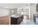 Open concept kitchen and living room featuring an island and ample light at 15207 Peaceful Bull Pl, Bradenton, FL 34212