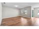 Bright living room featuring hardwood floors, neutral wall color, and a large window for natural light at 15207 Peaceful Bull Pl, Bradenton, FL 34212
