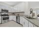 Bright kitchen with stainless steel appliances, white cabinets, and granite countertops at 16016 Sunny Day Dr, Bradenton, FL 34211