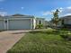 Charming single-story home with a well-manicured lawn, brick driveway and two car garage at 16120 Ivy Ridge Ct, Port Charlotte, FL 33953