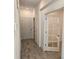 Bright hallway with wood-look tile flooring and access to multiple rooms at 16120 Ivy Ridge Ct, Port Charlotte, FL 33953