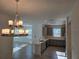 Open-concept kitchen with elegant lighting, quartz countertops, modern stainless appliances and gray cabinets at 16120 Ivy Ridge Ct, Port Charlotte, FL 33953