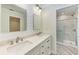 Bright bathroom featuring a double vanity, quartz countertop, and a walk-in shower at 2601 13Th W St, Palmetto, FL 34221