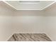 A bright empty room with wood-look floors and a skylight, ready for customization at 2601 13Th W St, Palmetto, FL 34221