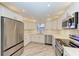 Modern kitchen boasts stainless steel appliances, sleek white cabinetry, and beautiful countertops at 2601 13Th W St, Palmetto, FL 34221
