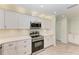 Modern kitchen boasts stainless steel appliances and sleek white cabinetry at 2601 13Th W St, Palmetto, FL 34221