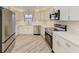Modern kitchen boasts stainless steel appliances, sleek white cabinetry, and beautiful countertops at 2601 13Th W St, Palmetto, FL 34221