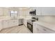 Modern kitchen boasts stainless steel appliances, sleek white cabinetry, and beautiful countertops at 2601 13Th W St, Palmetto, FL 34221