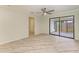 Open living room featuring sliding glass doors, ceiling fan, and neutral paint, flowing into the kitchen at 2601 13Th W St, Palmetto, FL 34221