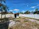 Backyard featuring a shed, white fence, and a grassy area at 2727 Waldemere St, Sarasota, FL 34239