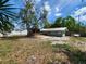 Backyard featuring a screen porch, a white fence and a gray house at 2727 Waldemere St, Sarasota, FL 34239