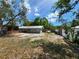 Backyard featuring a screen porch, a white fence and a gray house at 2727 Waldemere St, Sarasota, FL 34239