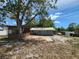 Backyard featuring a screen porch, a white fence and a gray house at 2727 Waldemere St, Sarasota, FL 34239