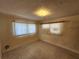 Bedroom featuring neutral carpet, natural light from windows, and a simple ceiling light fixture at 2727 Waldemere St, Sarasota, FL 34239