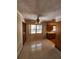 Cozy dining room featuring tile flooring, a ceiling fan, a large window, and access to the kitchen at 2727 Waldemere St, Sarasota, FL 34239